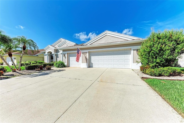 11915 Oak Ridge Dr, Parrish, FL 34219 - ranch-style house featuring concrete driveway, an attached garage, and stucco siding