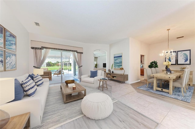 11915 Oak Ridge Dr, Parrish, FL 34219 - living area featuring a chandelier, arched walkways, and tile patterned flooring