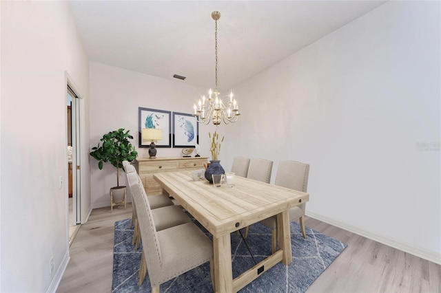 11915 Oak Ridge Dr, Parrish, FL 34219 - dining area featuring a chandelier and light wood-style floors