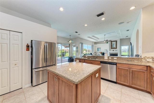 11915 Oak Ridge Dr, Parrish, FL 34219 - kitchen with stainless steel appliances, ceiling fan, light tile patterned floors, light stone countertops, and recessed lighting