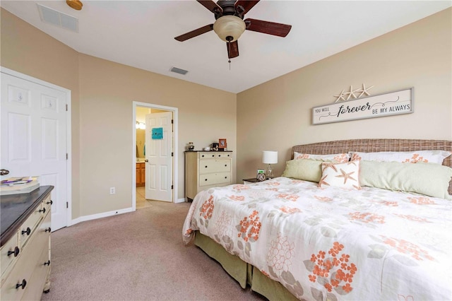 3698 Parkridge Cir Unit 26-104, Sarasota, FL 34243 - bedroom with light colored carpet, ceiling fan, and ensuite bath
