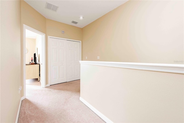 3698 Parkridge Cir Unit 26-104, Sarasota, FL 34243 - hallway with light carpet and baseboards