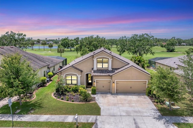 9123 Raes Creek Pl, Palmetto, FL 34221 - view of front of home featuring stucco siding, driveway, a water view, a front yard, and a garage