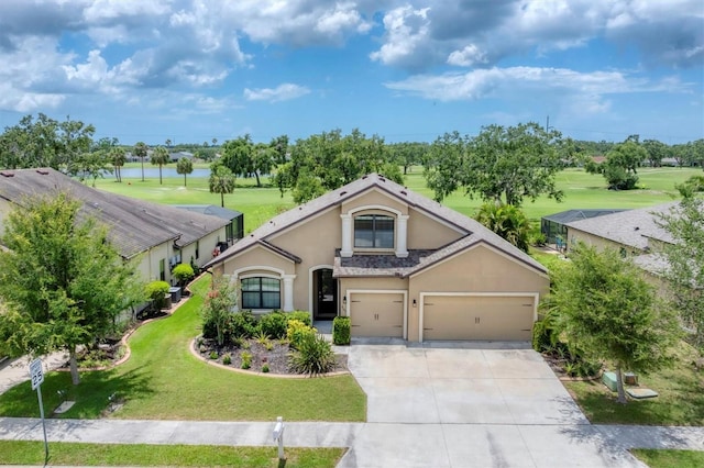 9123 Raes Creek Pl, Palmetto, FL 34221 - view of front facade featuring stucco siding, driveway, a front yard, view of golf course, and a garage