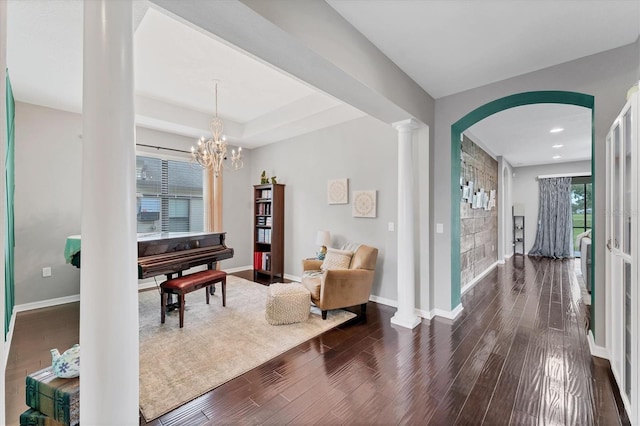 9123 Raes Creek Pl, Palmetto, FL 34221 - sitting room with dark wood-style flooring, arched walkways, recessed lighting, and a chandelier