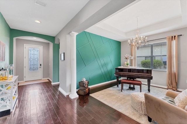 9123 Raes Creek Pl, Palmetto, FL 34221 - foyer featuring dark wood-style floors, arched walkways, a chandelier, recessed lighting, and a raised ceiling