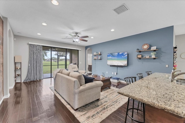 9123 Raes Creek Pl, Palmetto, FL 34221 - living room featuring arched walkways, dark wood-type flooring, recessed lighting, and ceiling fan