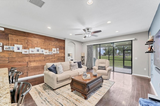 9123 Raes Creek Pl, Palmetto, FL 34221 - living room with wood walls, ceiling fan, recessed lighting, and wood finished floors