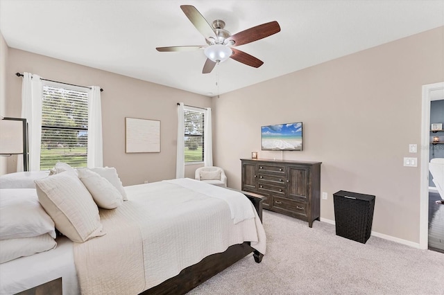 9123 Raes Creek Pl, Palmetto, FL 34221 - bedroom featuring multiple windows, light carpet, and ceiling fan