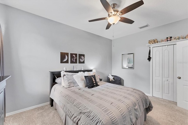 9123 Raes Creek Pl, Palmetto, FL 34221 - bedroom with light colored carpet, a closet, and a ceiling fan
