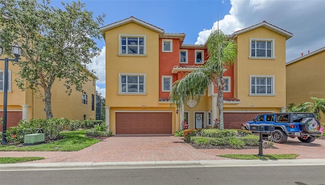1512 3rd Street Cir E, Palmetto, FL 34221 - multi unit property with a garage, decorative driveway, stucco siding, and a tile roof