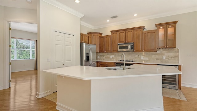 1512 3rd Street Cir E, Palmetto, FL 34221 - kitchen featuring appliances with stainless steel finishes, wine cooler, light wood-style floors, a large island, and light countertops