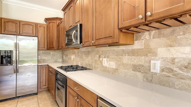 1512 3rd Street Cir E, Palmetto, FL 34221 - kitchen featuring stainless steel appliances, ornamental molding, light countertops, brown cabinets, and backsplash