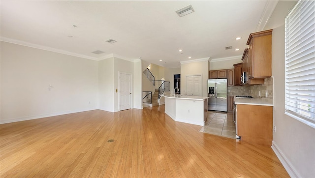 1512 3rd Street Cir E, Palmetto, FL 34221 - kitchen with appliances with stainless steel finishes, a kitchen island with sink, open floor plan, light wood-style flooring, and recessed lighting