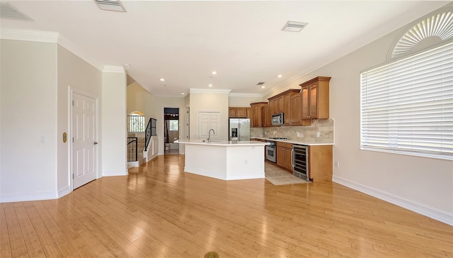 1512 3rd Street Cir E, Palmetto, FL 34221 - kitchen with wine cooler, stainless steel appliances, light countertops, brown cabinets, and backsplash