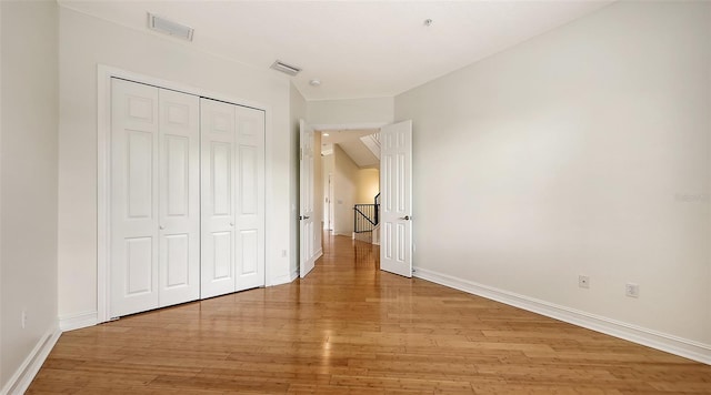 1512 3rd Street Cir E, Palmetto, FL 34221 - unfurnished bedroom featuring light wood-style floors and a closet