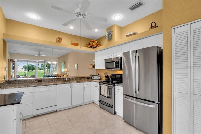 6908 Stoneywalk Ct, Bradenton, FL 34203 - kitchen featuring stainless steel appliances, a ceiling fan, white cabinets, light tile patterned flooring, and dark stone countertops