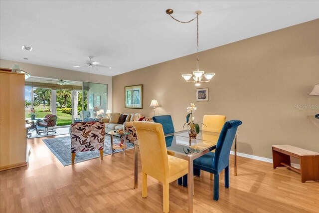 6908 Stoneywalk Ct, Bradenton, FL 34203 - dining space featuring light wood-style flooring, ceiling fan, and a chandelier
