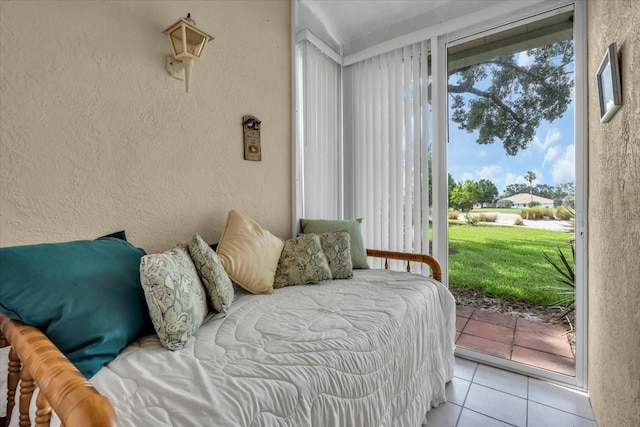 6908 Stoneywalk Ct, Bradenton, FL 34203 - bedroom with a textured wall, access to outside, and tile patterned floors