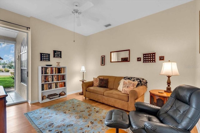 6908 Stoneywalk Ct, Bradenton, FL 34203 - living area with wood finished floors and a ceiling fan
