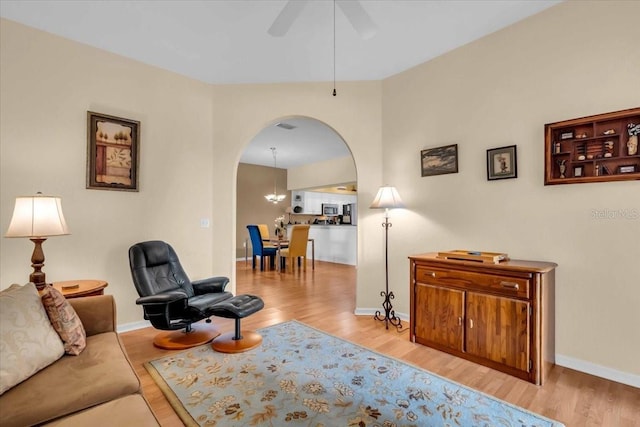 6908 Stoneywalk Ct, Bradenton, FL 34203 - living area featuring arched walkways, wood finished floors, and ceiling fan
