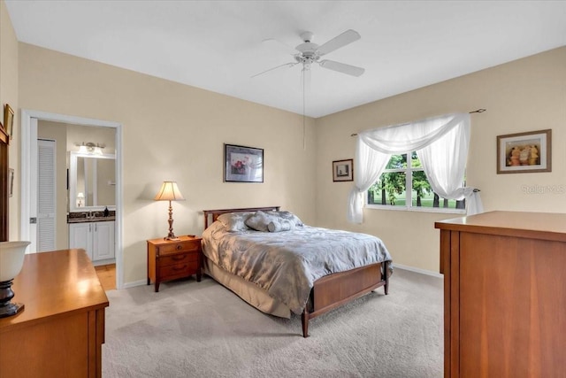 6908 Stoneywalk Ct, Bradenton, FL 34203 - bedroom with light colored carpet, connected bathroom, and a ceiling fan