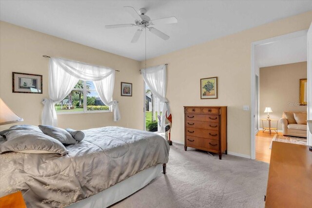 6908 Stoneywalk Ct, Bradenton, FL 34203 - carpeted bedroom featuring a ceiling fan and baseboards