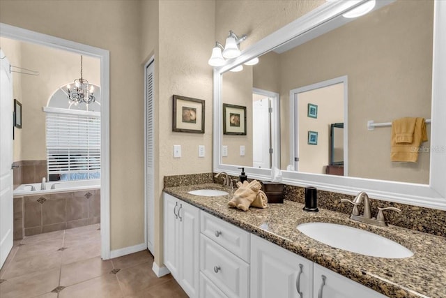 6908 Stoneywalk Ct, Bradenton, FL 34203 - bathroom with double vanity, tile patterned floors, a garden tub, and a chandelier
