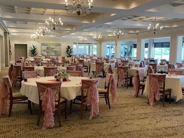 6908 Stoneywalk Ct, Bradenton, FL 34203 - dining space with a chandelier, coffered ceiling, and beam ceiling