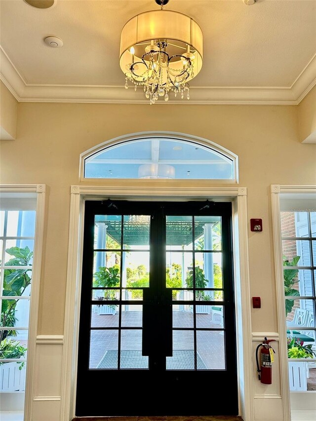 6908 Stoneywalk Ct, Bradenton, FL 34203 - doorway with healthy amount of natural light, french doors, crown molding, and a chandelier