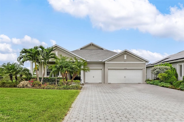 17204 Bullhorn Cir, Punta Gorda, FL 33982 - ranch-style house with decorative driveway, an attached garage, stucco siding, a front yard, and a shingled roof