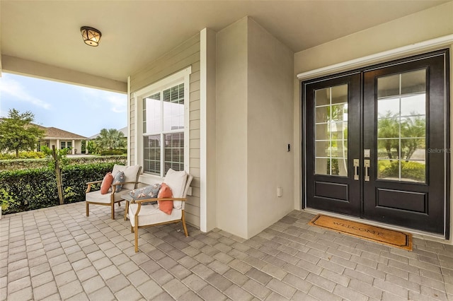 17204 Bullhorn Cir, Punta Gorda, FL 33982 - entrance to property with french doors, a porch, and stucco siding