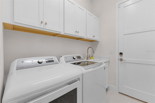 17204 Bullhorn Cir, Punta Gorda, FL 33982 - laundry area featuring washing machine and dryer, cabinet space, and light tile patterned flooring