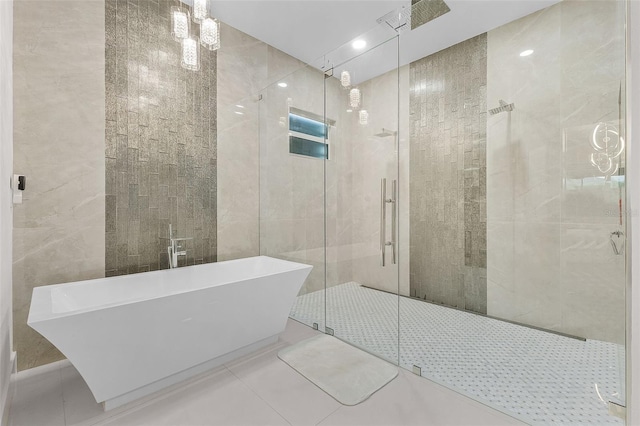 17204 Bullhorn Cir, Punta Gorda, FL 33982 - bathroom featuring a freestanding bath, tile walls, a stall shower, and tile patterned floors