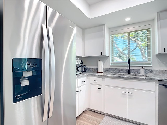 516 Parkdale Mews Unit 516, Venice, FL 34285 - kitchen with stainless steel appliances, white cabinets, light stone countertops, light wood finished floors, and recessed lighting