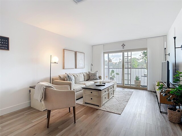 516 Parkdale Mews Unit 516, Venice, FL 34285 - living room with light wood finished floors and baseboards