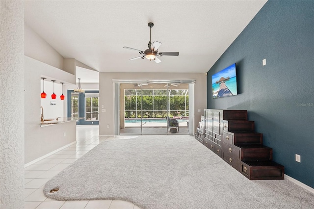 25433 Colon Dr, Punta Gorda, FL 33983 - living area with lofted ceiling, a textured wall, ceiling fan, and tile patterned floors