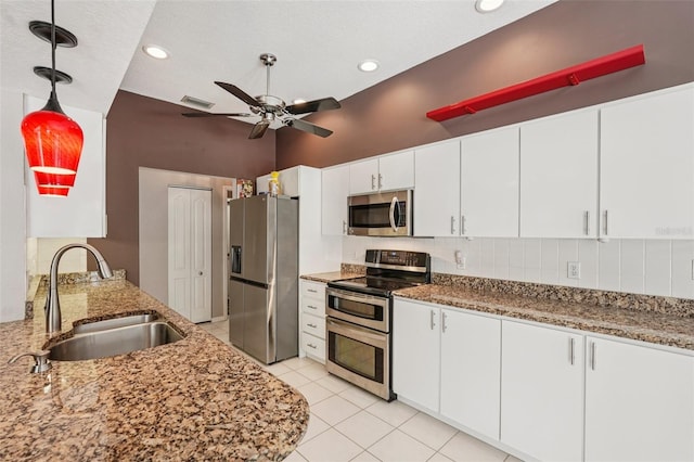 25433 Colon Dr, Punta Gorda, FL 33983 - kitchen with stainless steel appliances, ceiling fan, light stone countertops, white cabinets, and recessed lighting