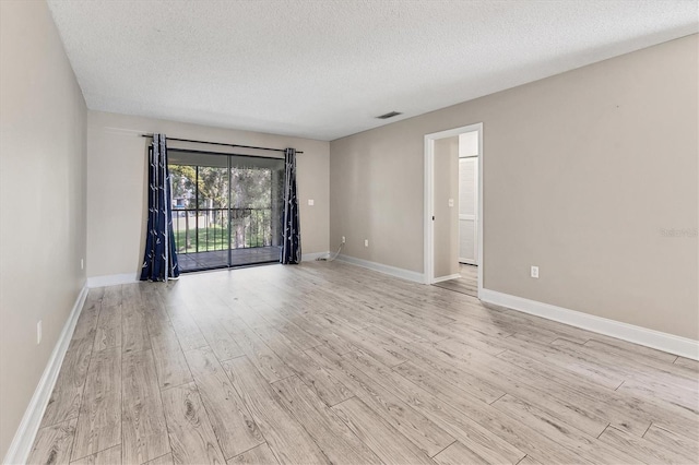 7866 Eagle Creek Dr Unit 7866, Sarasota, FL 34243 - spare room featuring light wood-style floors and a textured ceiling