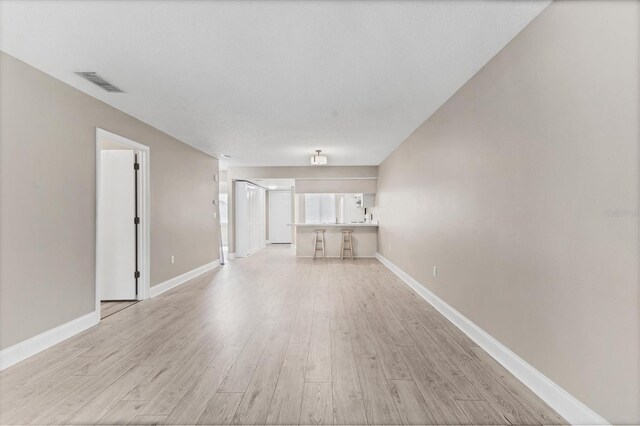 7866 Eagle Creek Dr Unit 7866, Sarasota, FL 34243 - unfurnished living room with light wood-style flooring and baseboards