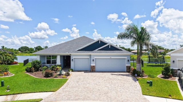 5910 Hevena Ct, Palmetto, FL 34221 - view of front of house featuring a garage, decorative driveway, a front yard, and stucco siding