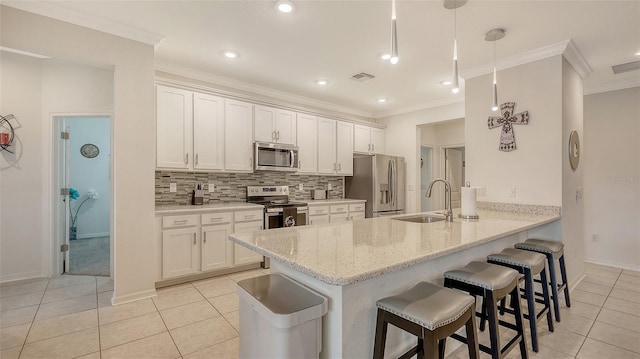 5910 Hevena Ct, Palmetto, FL 34221 - kitchen featuring appliances with stainless steel finishes, light tile patterned floors, a peninsula, a kitchen breakfast bar, and ornamental molding