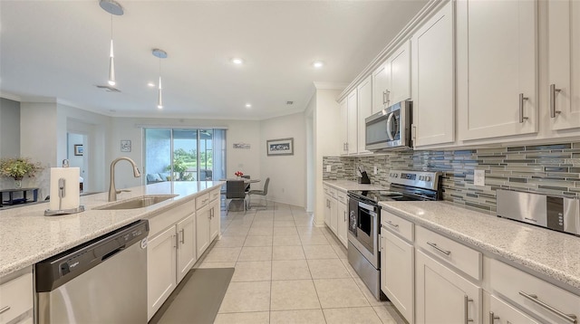5910 Hevena Ct, Palmetto, FL 34221 - kitchen featuring stainless steel appliances, ornamental molding, backsplash, white cabinets, and light tile patterned floors