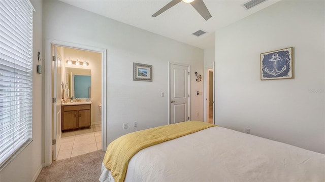 5910 Hevena Ct, Palmetto, FL 34221 - bedroom featuring light carpet, connected bathroom, light tile patterned flooring, and ceiling fan