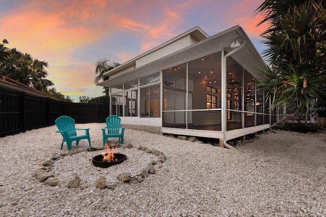 9122 16th Avenue Cir NW, Bradenton, FL 34209 - back of property featuring a sunroom and a fire pit