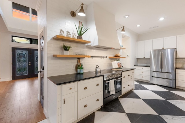 9122 16th Avenue Cir NW, Bradenton, FL 34209 - kitchen with appliances with stainless steel finishes, open shelves, dark countertops, custom range hood, and tasteful backsplash