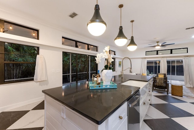 9122 16th Avenue Cir NW, Bradenton, FL 34209 - kitchen featuring dishwasher, a kitchen island with sink, white cabinetry, ceiling fan, and pendant lighting