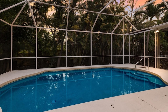 9122 16th Avenue Cir NW, Bradenton, FL 34209 - pool at dusk with an outdoor pool, glass enclosure, and a patio area
