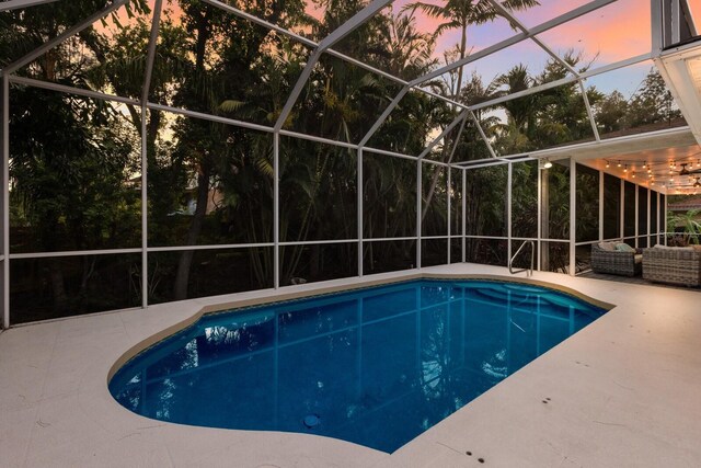 9122 16th Avenue Cir NW, Bradenton, FL 34209 - pool at dusk with an outdoor pool, a patio area, outdoor lounge area, and a lanai
