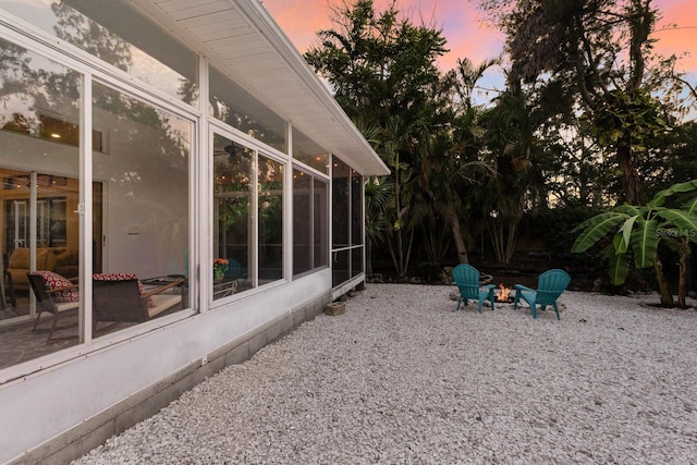 9122 16th Avenue Cir NW, Bradenton, FL 34209 - view of yard featuring a sunroom, a fire pit, and a patio area